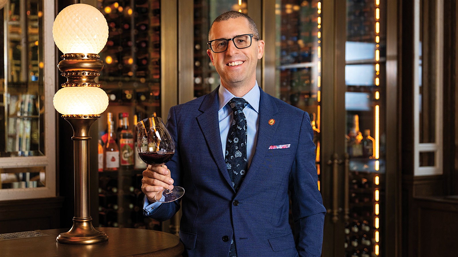 Josh Nadel holding a glass of wine at Carne Mare in New York